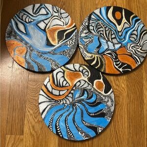Hand painted one of a kind sent of three abstract circular 10 by 10 paintings.